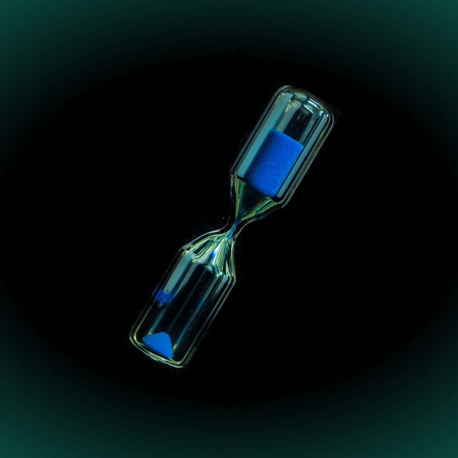 Glass hourglass with blue sand